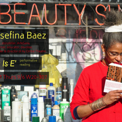 A woman stands in front of a store display, reading a book